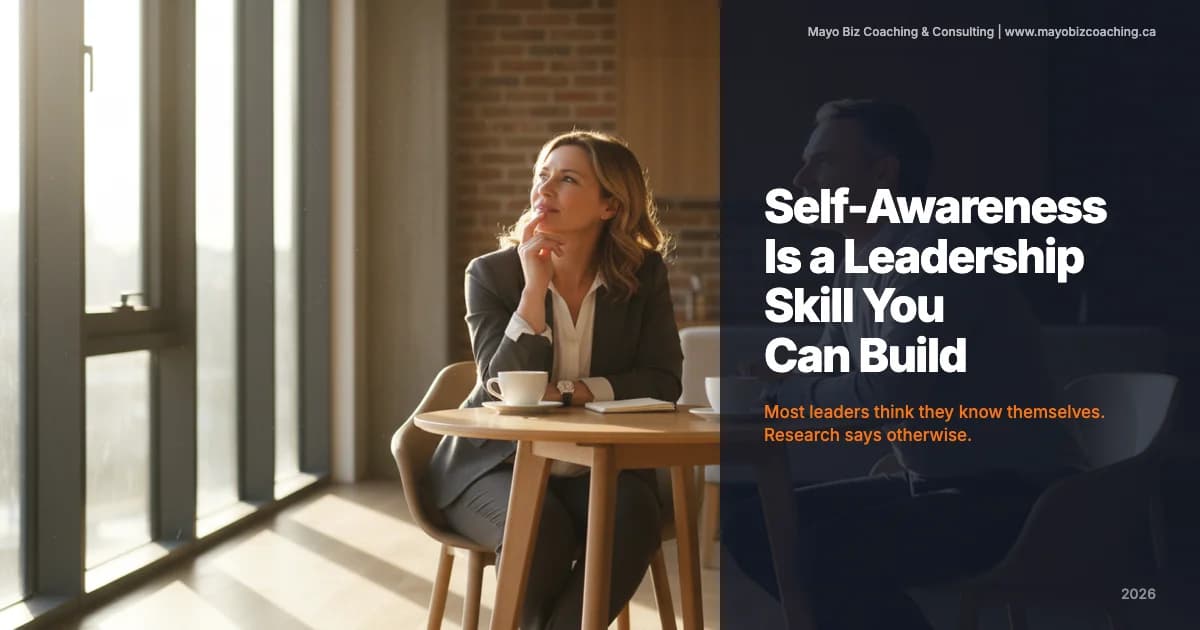 Business leader in a quiet reflective moment during a coaching conversation in a warm modern office