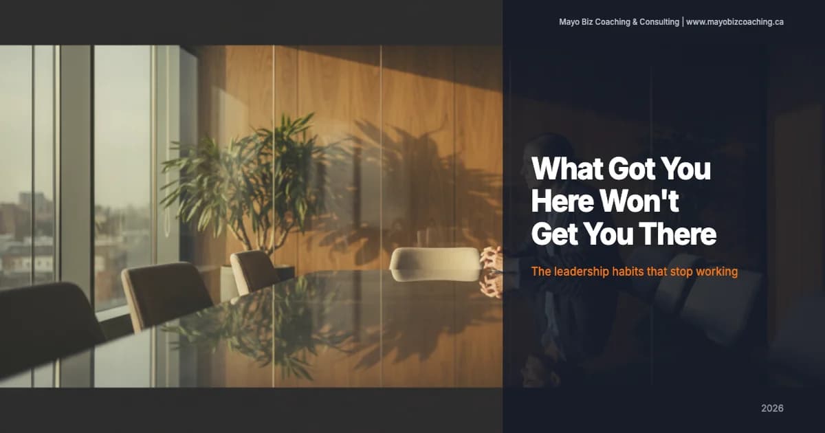 Business leader pausing in thought during a one-on-one coaching conversation in a warm modern office