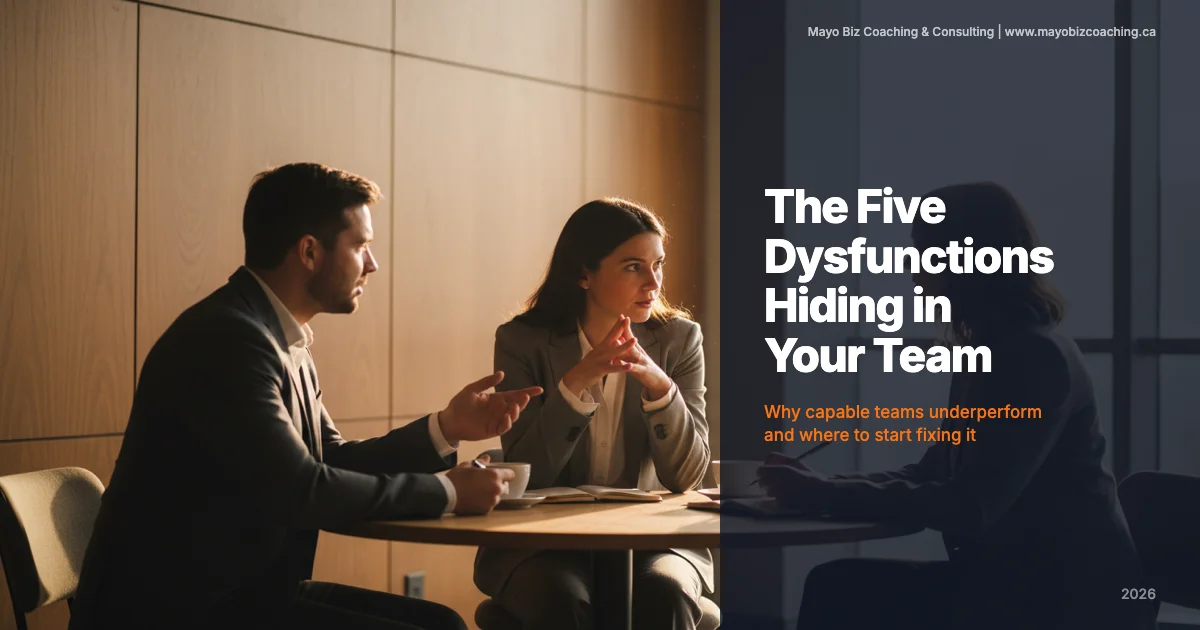 Business coach leading a candid team conversation around a table in a warm modern office