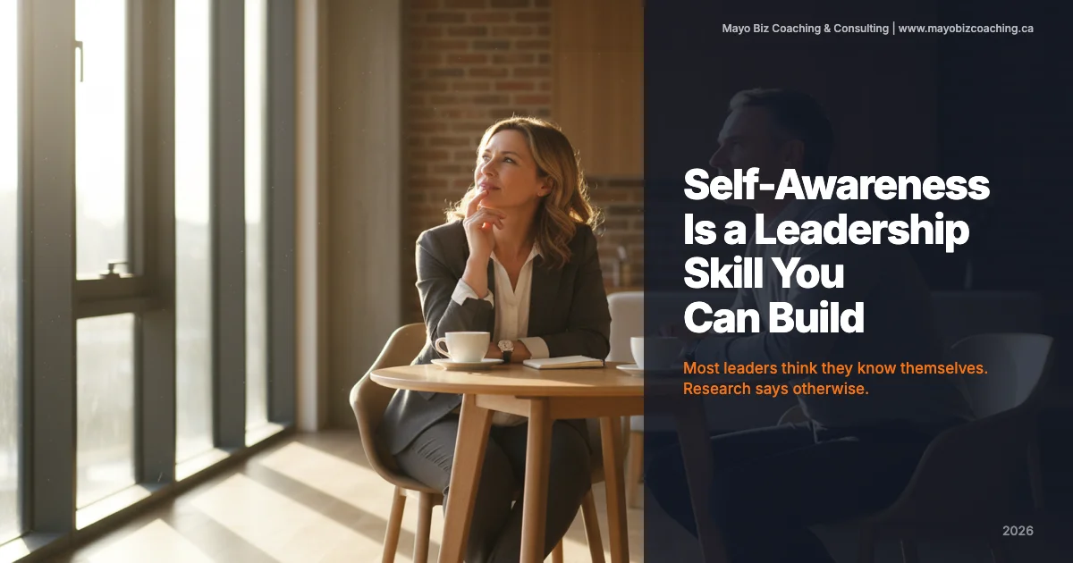 Business leader in a quiet reflective moment during a coaching conversation in a warm modern office