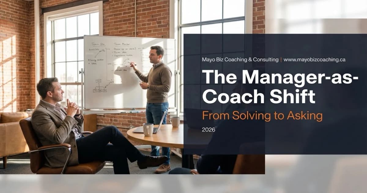 Manager listening while team member works through a problem on a whiteboard in a warm modern office