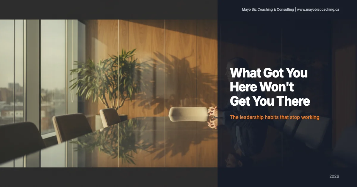 Business leader pausing in thought during a one-on-one coaching conversation in a warm modern office