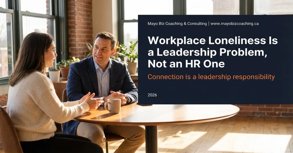 A leader and team member in genuine one-on-one conversation at a small office, illustrating the human connection that addresses workplace loneliness