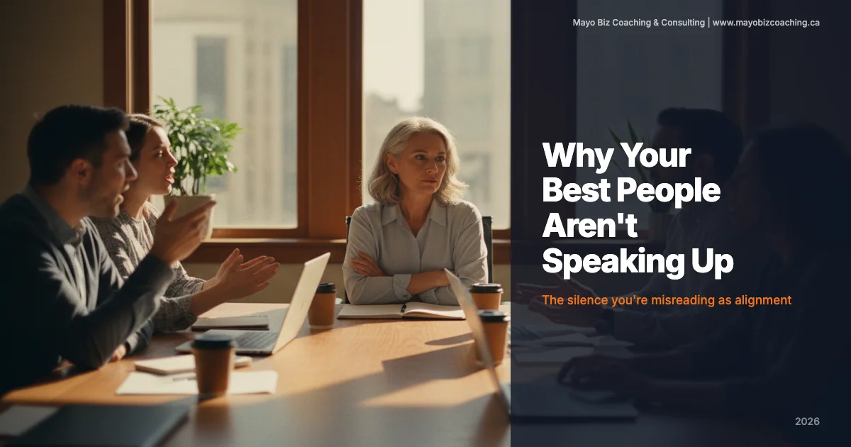 Business leader listening carefully to a team member in a one-on-one coaching conversation in a modern office