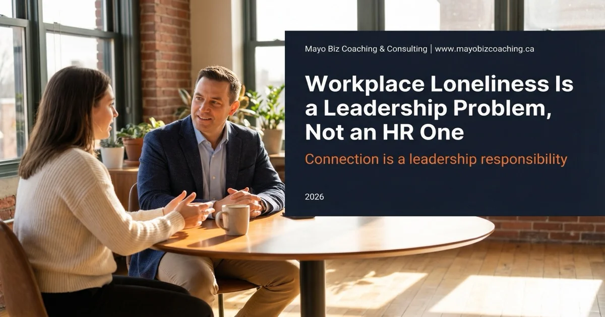 A leader and team member in genuine one-on-one conversation at a small office, illustrating the human connection that addresses workplace loneliness